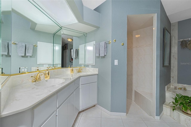 bathroom with a walk in shower, double vanity, a sink, and tile patterned flooring