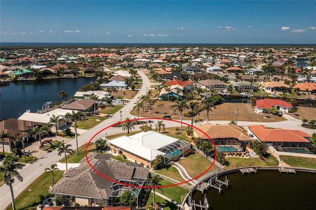 drone / aerial view featuring a residential view and a water view