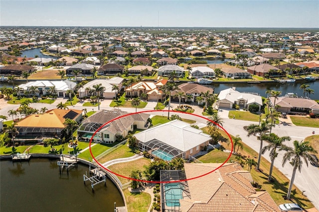 drone / aerial view with a water view and a residential view