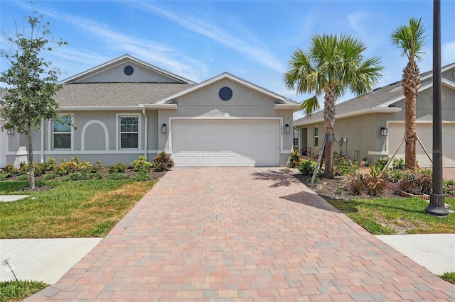 16079 Bandermill Dr, Port Charlotte, FL 33953 - ranch-style home with an attached garage, decorative driveway, stucco siding, and a front yard