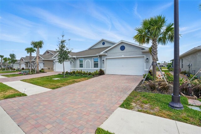 16079 Bandermill Dr, Port Charlotte, FL 33953 - ranch-style house featuring decorative driveway, a garage, stucco siding, and a front yard