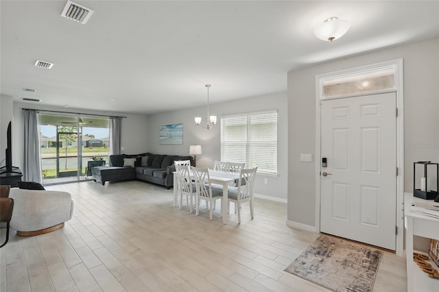 16079 Bandermill Dr, Port Charlotte, FL 33953 - dining room with a chandelier, light wood-style floors, and baseboards