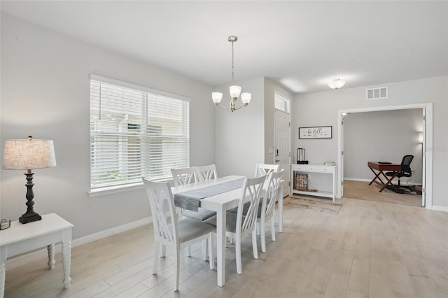 16079 Bandermill Dr, Port Charlotte, FL 33953 - dining area with a chandelier, light wood-type flooring, and baseboards