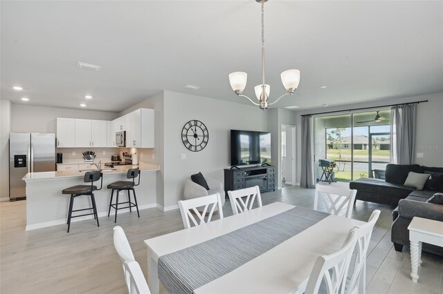 16079 Bandermill Dr, Port Charlotte, FL 33953 - dining room featuring recessed lighting, a chandelier, light wood finished floors, and baseboards