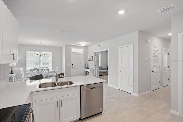 16079 Bandermill Dr, Port Charlotte, FL 33953 - kitchen featuring stainless steel appliances, a sink, white cabinetry, a peninsula, and light countertops