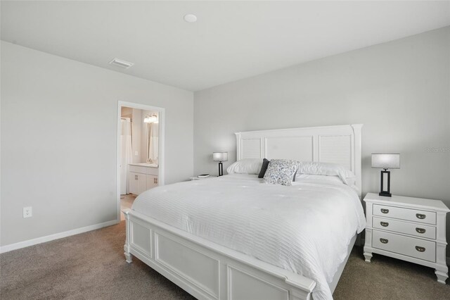 16079 Bandermill Dr, Port Charlotte, FL 33953 - bedroom with dark carpet, baseboards, and ensuite bathroom