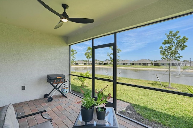 16079 Bandermill Dr, Port Charlotte, FL 33953 - unfurnished sunroom featuring a water view, a ceiling fan, and a residential view