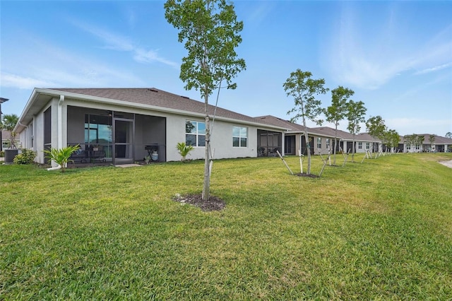 16079 Bandermill Dr, Port Charlotte, FL 33953 - rear view of property with a sunroom, a yard, stucco siding, and cooling unit
