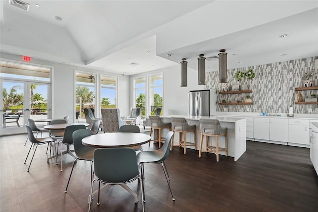16079 Bandermill Dr, Port Charlotte, FL 33953 - dining room featuring wallpapered walls, french doors, dark wood-style floors, and lofted ceiling