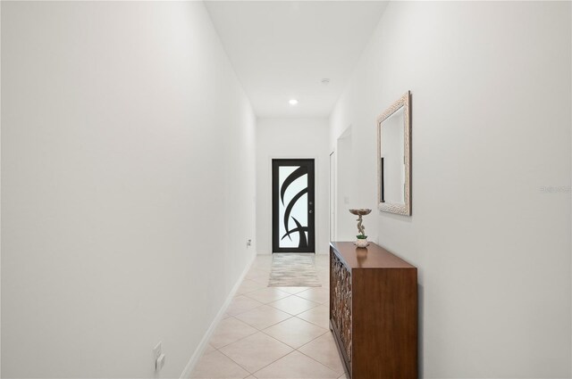 doorway to outside with light tile patterned floors, baseboards, and recessed lighting