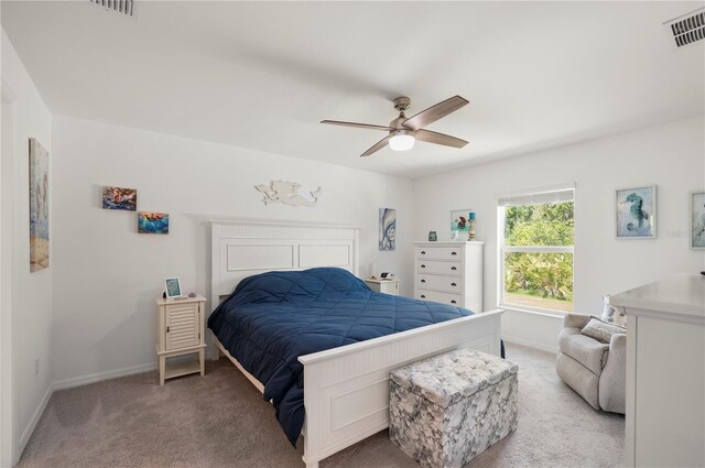 bedroom with light colored carpet, baseboards, and ceiling fan