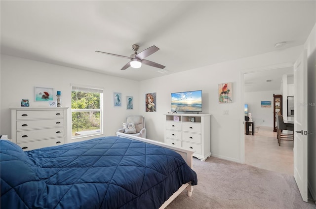 bedroom with light carpet, ceiling fan, and baseboards