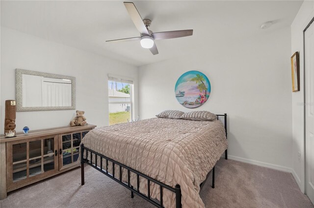 carpeted bedroom with baseboards and a ceiling fan