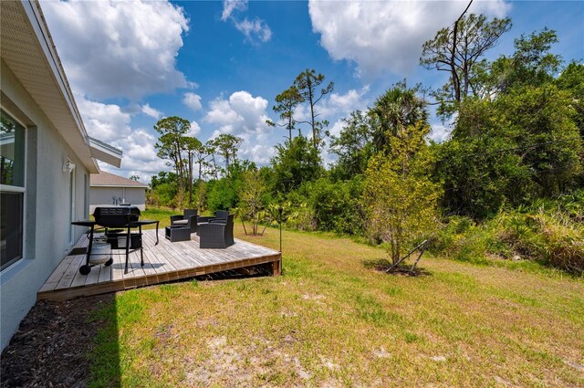 view of green lawn with a wooden deck and an outdoor living space