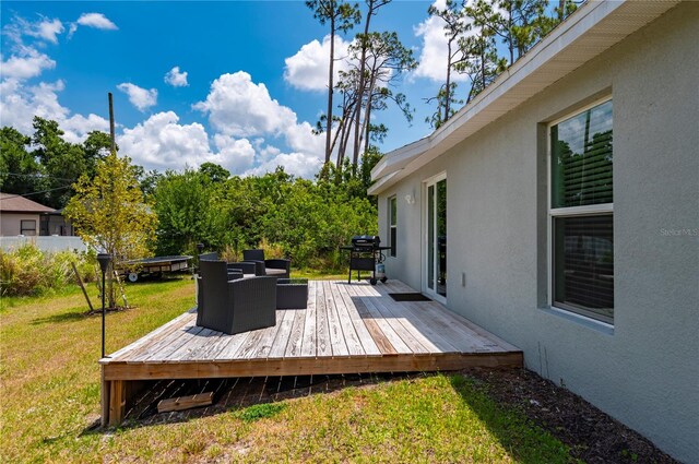 wooden deck featuring a yard and area for grilling
