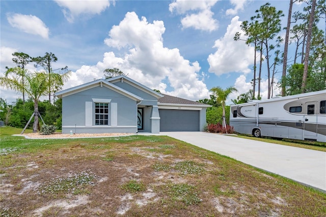 view of front of house featuring driveway, a garage, and stucco siding