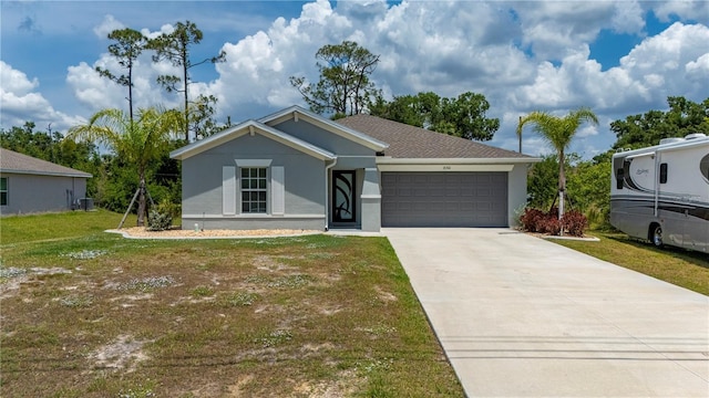 ranch-style home with a garage, stucco siding, driveway, and a front lawn
