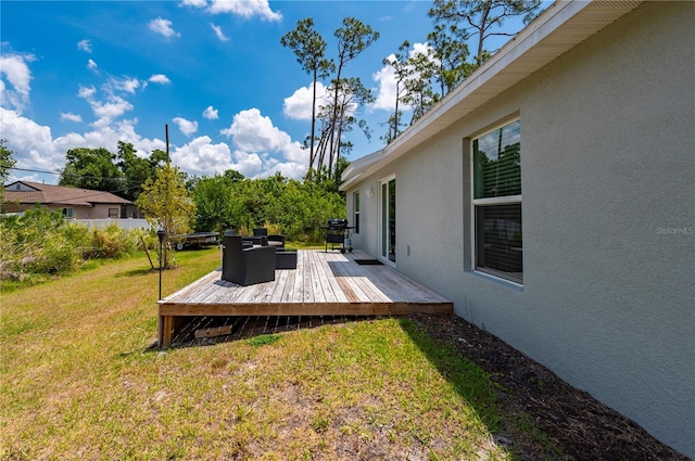 view of green lawn featuring a wooden deck
