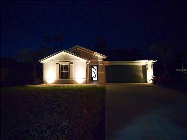 single story home with driveway, a garage, and stucco siding