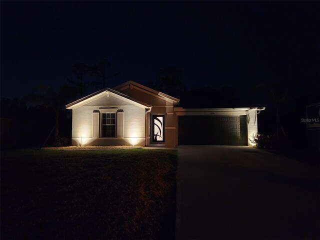 ranch-style house featuring driveway and an attached garage