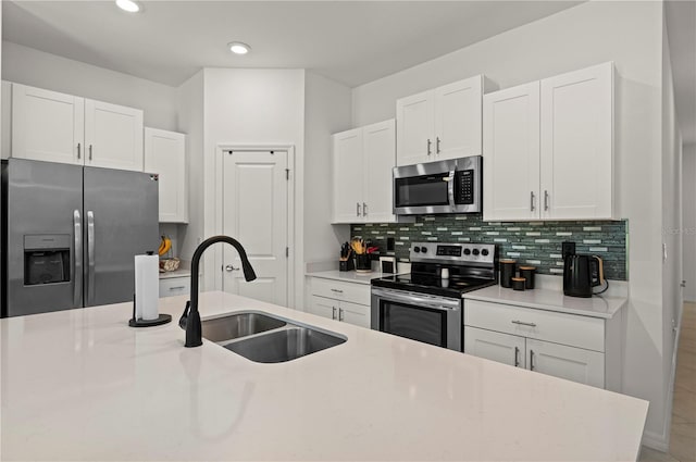 21310 Quesada Ave, Port Charlotte, FL 33952 - kitchen with appliances with stainless steel finishes, white cabinets, backsplash, light countertops, and recessed lighting