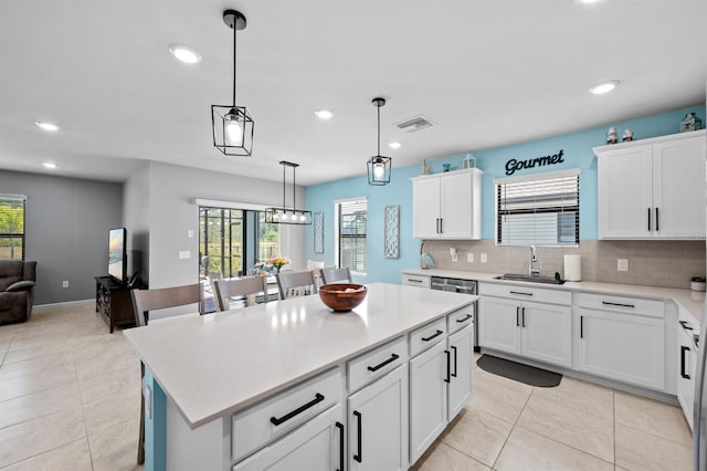 16016 Shoebutton Ct, North Fort Myers, FL 33917 - kitchen featuring a sink, light countertops, tasteful backsplash, and plenty of natural light