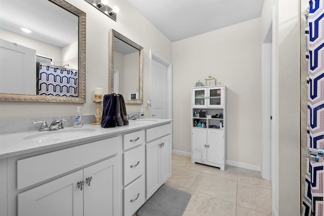 16016 Shoebutton Ct, North Fort Myers, FL 33917 - full bath featuring baseboards, double vanity, tile patterned floors, and a sink