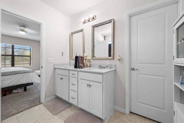 16016 Shoebutton Ct, North Fort Myers, FL 33917 - bathroom with double vanity, baseboards, tile patterned floors, and ensuite bath