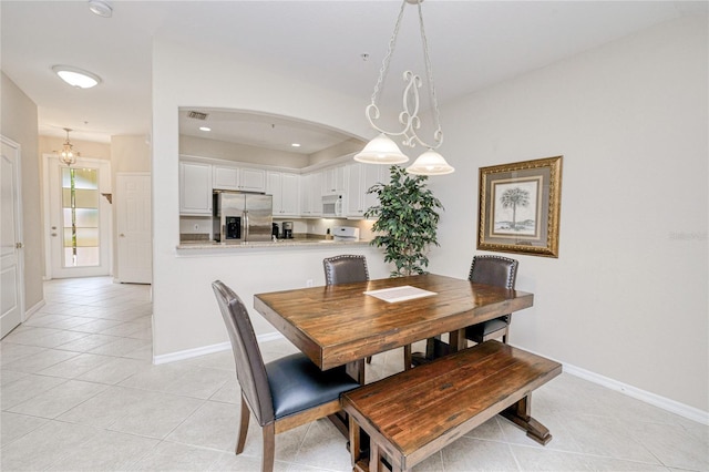 dining area with light tile patterned floors and baseboards