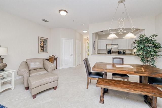 dining room with baseboards and light tile patterned floors