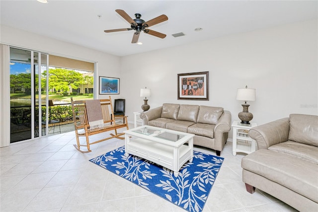 living room featuring light tile patterned flooring, a ceiling fan, recessed lighting, and baseboards