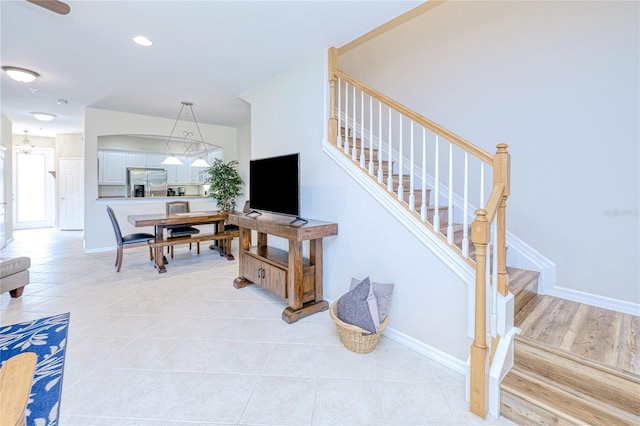 stairs featuring baseboards and tile patterned flooring
