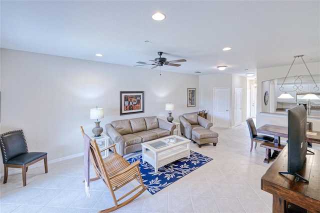living area with light tile patterned floors, recessed lighting, a ceiling fan, and baseboards