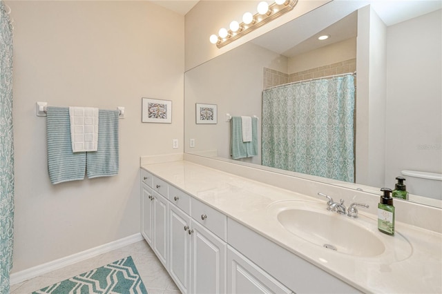 bathroom featuring tile patterned floors, vanity, baseboards, and a shower with shower curtain