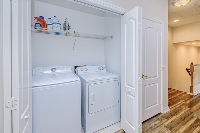 washroom with separate washer and dryer and light wood-type flooring