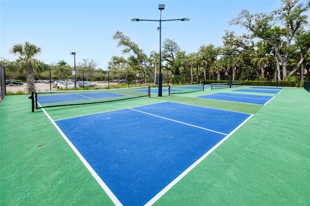 view of tennis court with fence