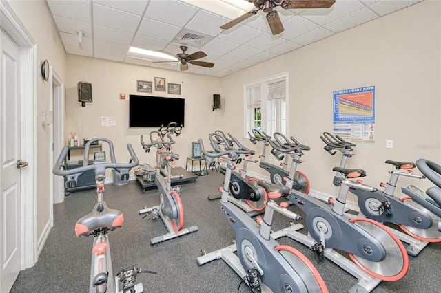 exercise room featuring a drop ceiling and a ceiling fan