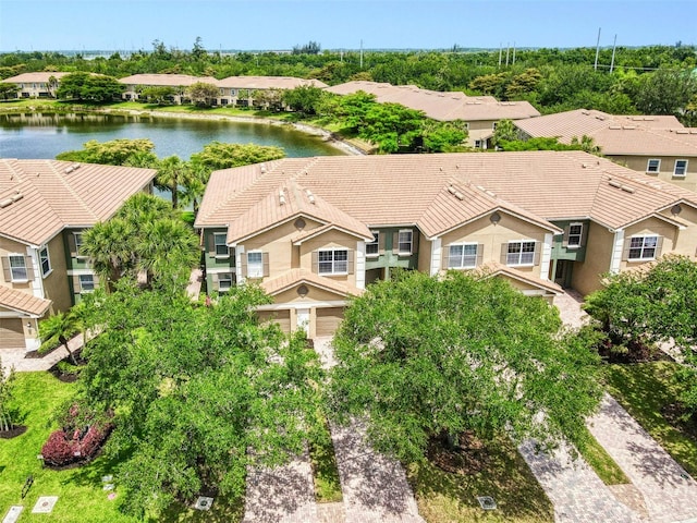 aerial view of residential area featuring a large body of water