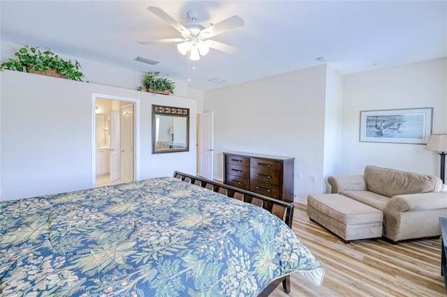 bedroom featuring light wood-type flooring, ceiling fan, and ensuite bathroom