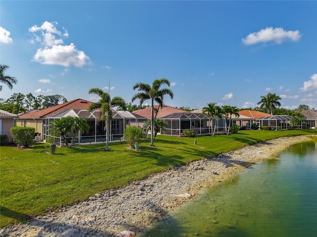 view of front of home featuring a residential view, a water view, and a front yard
