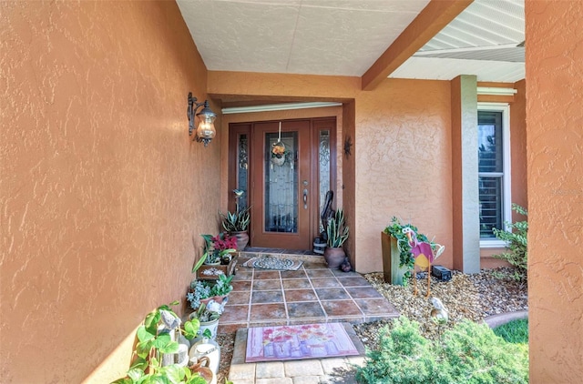 entrance to property with stucco siding