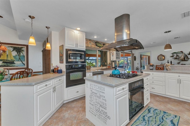 kitchen featuring appliances with stainless steel finishes, island exhaust hood, light tile patterned flooring, a peninsula, and a kitchen island