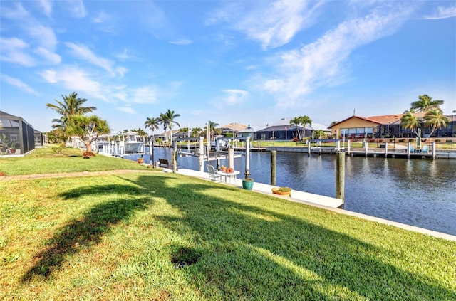 dock area featuring a residential view, a water view, a lawn, and boat lift