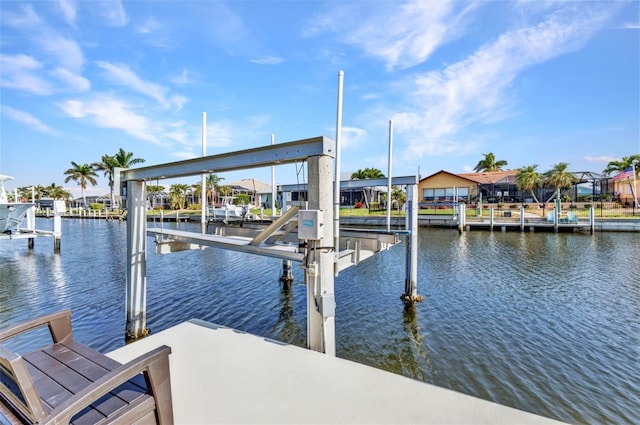 dock area featuring boat lift and a water view