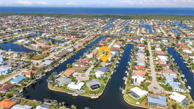 aerial view of property's location with a large body of water and nearby suburban area