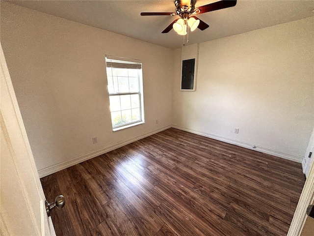 spare room featuring baseboards, ceiling fan, electric panel, and wood finished floors