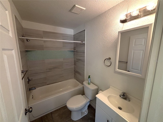 bathroom featuring toilet, a textured ceiling, visible vents, tile patterned flooring, and vanity
