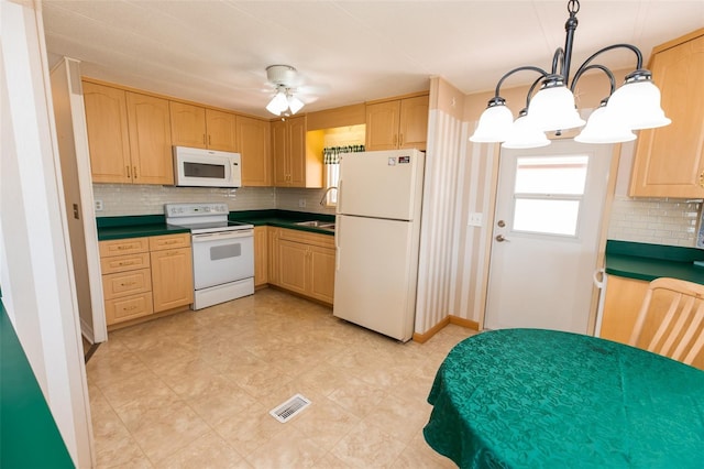 643 Blackburn Blvd, North Port, FL 34287 - kitchen with white appliances, dark countertops, tasteful backsplash, light brown cabinets, and a ceiling fan