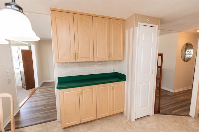 643 Blackburn Blvd, North Port, FL 34287 - kitchen with light brown cabinetry, decorative backsplash, baseboards, and dark countertops