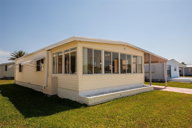 643 Blackburn Blvd, North Port, FL 34287 - view of side of home with a yard and a sunroom